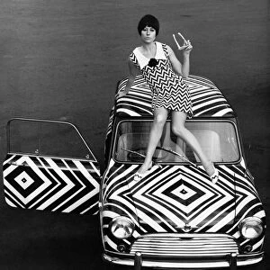 The Mini motorcar that has received the Op-Art treatment from an amateur with a pair of