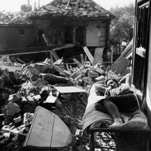 Miss D Hubert age 16 having delved among the wreckage of the top flat, takes a rest Miss D Hubert age 16 having delved among the wreckage of the top flat, takes a rest
