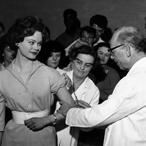 Miss England 1959 Miss Pamela Searle receives her polio vaccination in public to