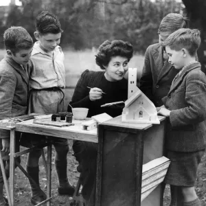 Miss. Loewy niece of Mr. Somerfield showing the children how to paint the cast pieces Miss. Loewy niece of Mr. Somerfield showing the children how to paint the cast pieces