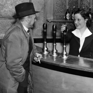 Miss Nora Collins chatting with a customer in her public house, 21st March 1938 Miss Nora Collins chatting with a customer in her public house, 21st March 1938