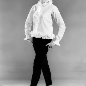 Model Annie Alliston wearing long sleeved frilly top. March 1962 P008903