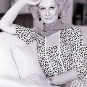April Ashley Sitting on a Sofa in Print Dress May 1982