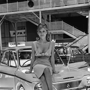 Model drapped over a Rootes Chamois car at the British International Motor Show in London