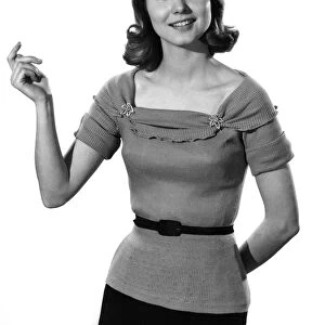 Model Helen Laundy wearing short sleeved top and belt. April 1961 P008827
