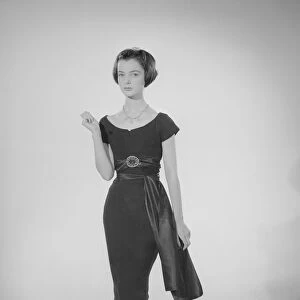 Model Jennifer Goddard. Young woman in short dressy black dress