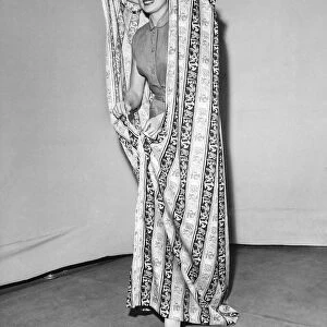 Model Julie Wilson wearing a printed mobile changing curtain June 1951