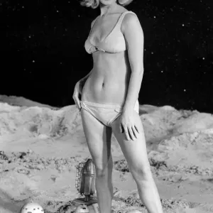 Model June Cooper in a bikini poses on a moon-themed backdrop, print Model June Cooper in a bikini poses on a moon-themed backdrop, print