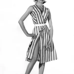 Model Margaret Lorraine wearing striped sleeveless dress with bellt