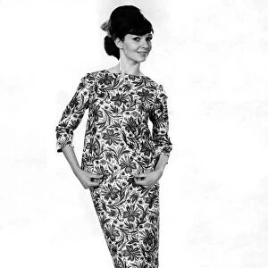 Model Merriel Weston wearing a floral patterned top and matching skirt. May 1964 P007544