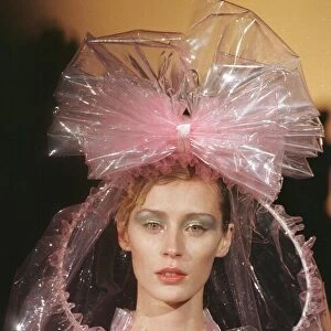 Top model pink plastic dress under a pink plastic cape designed by Paco Rabanne for his