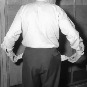 Model poses to illustrate a luck of funds. 29th April 1954 Model poses to illustrate a luck of funds. 29th April 1954