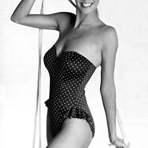 Model posing in a navy and white polkadot strapless swimsuit from Marks and Spencers (17