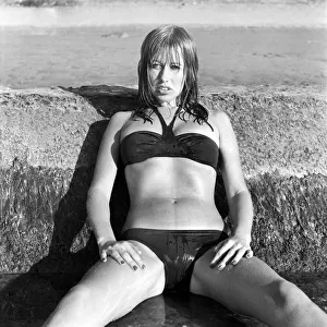 Model wearing a bikini as she poses on a beach in Africa April 1975