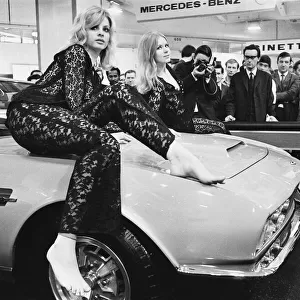 Models drapped over the bonnet of an Aston Martin DBS V8 at the 1969 Motor Show 1st June