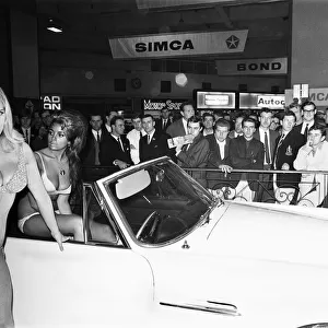 Models drapped over cars at the London Motor Show 18th October 1966