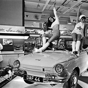 Models drapped over a DAF 44 car at the London Motor Show 18th October 1966