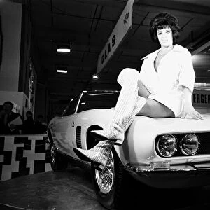 Models drapped over the latest Iso Grifo car at the 1966 London Motor Show 18th October
