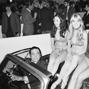 Models are driven to their stand at the 1971 Earls Court motor show 19th October 1971