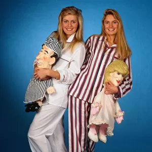 Models wearing mens pyjamas holding Princess Diana and Prince Charles pyjama cases