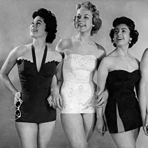 Four models wearing one piece swimsuits. March 1955 P018066