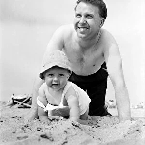 Nine month old Paul Kemshell crawling on the sands at Rhyl with his daddy Mr