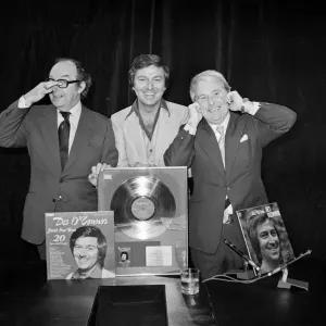 Morecambe and Wise present Des O Connor with a golden disc to mark 100000 sales of Morecambe and Wise present Des O Connor with a golden disc to mark 100000 sales of