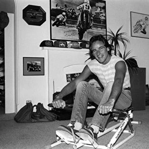 Motorcyclist Barry Sheene at home working out 1984 on rowing machine