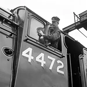 Mr Alan Pegler pictured cleaning The Flying Scotsman Engine window of the drivers cabin