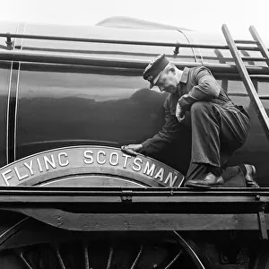 Mr Alan Pegler pictured cleaning The Flying Scotsman Engine name plate and wheel arch