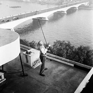 Mr. E. Drury, for a wager, cast a line from the roof of The Savoy Hotel to the river