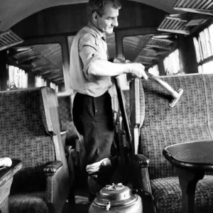 Mr. Frank Baley vacuums seats while cleaning a carriage ready for another journey on 10th Mr. Frank Baley vacuums seats while cleaning a carriage ready for another journey on 10th