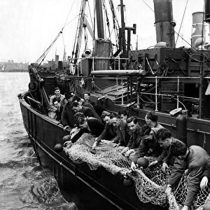 Mr A Hodgson teaching the trainee trawlermen to pay out the nets, ball floats first