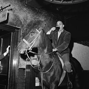 Mr Leslie Johnson rides his horse "Lady"into the bar of the Fox and Goose