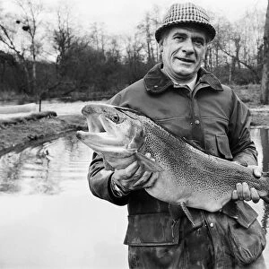 Mr Sam Holland (52) owner of Avington Trout Fishery, with a 3 year old Avington Strain