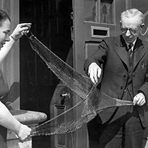 Mr. W. Fraser, stores manager at Irvins North Shields with a moedl trawl net in 1949