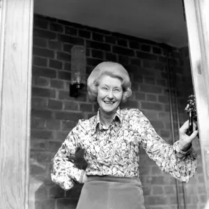 Mrs. Babette Barber looking out of her window. April 1975 75-2155 Mrs. Babette Barber looking out of her window. April 1975 75-2155