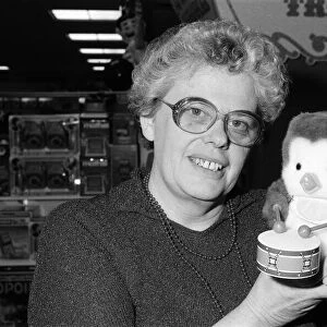 Mrs Beryl Bennington, Rackhams toy department manager, with a drumming penguin toy