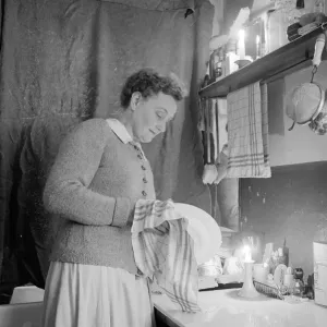 Mrs Dorothy Mead who still lights her house with gas lamps Seen here washing up by Mrs Dorothy Mead who still lights her house with gas lamps Seen here washing up by