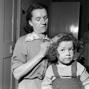 Mrs Gladys Batt attempting to clean her four-year-old daughter Georgina of paint Mrs Gladys Batt attempting to clean her four-year-old daughter Georgina of paint