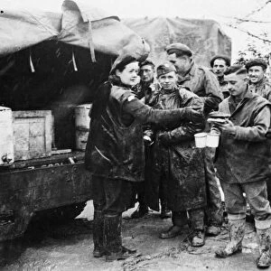 Mrs Jean Finnigan serves 5th army men their morning tea and buns. Mrs