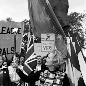 Mrs Margaret Thatcher holding the European flag under the statue of Sir Winston Churchill