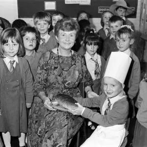 Mrs Rita Manchester receives a loaf of bread from six-year old Angela Chapman after a Mrs Rita Manchester receives a loaf of bread from six-year old Angela Chapman after a
