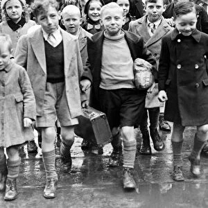 Mrs Rivers walking with evacuee children at St Pancras. They are returning from Suffolk