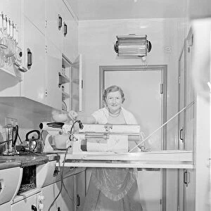 Mrs Susan Davies seen here using her rotary iron in a kitchen full of labour saving