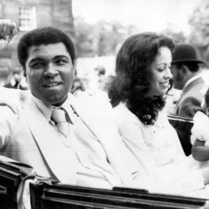 Print of Muhammad Ali with wife Veronica and baby daughter Hana in a landau