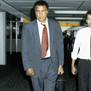 Muhammad Ali arriving at Heathrow airport after visiting war victims in Iran