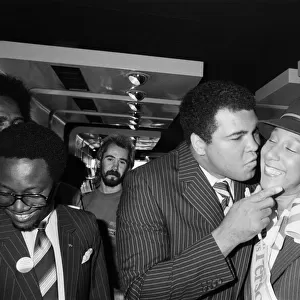 Muhammad Ali gives a British Airways hostess a kiss on his visit to Birmingham