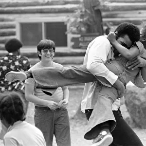 Muhammad Ali hugging a little girl at his training camp in Pennsylvania