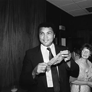 Muhammad Ali (left) shows off a conjuring trick when visiting Birmingham